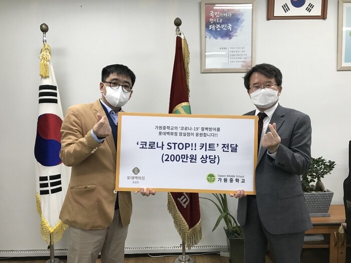 롯데백화점 잠실점과 가원중학교 '코로나19 STOP 키트' 전달식 모습. 사진 왼쪽부터 롯데백화점 잠실점 한태구 지원팀장, 사진 오른쪽 전찬규 가원중학교 교장.(사진=롯데쇼핑)